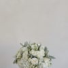 A classic, full-bodied arrangement featuring lush white blooms thoughtfully gathered into a