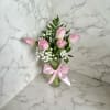 Pink tulips in a glass vase with a pink ribbon