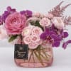 A lush, romantic bouquet built around a large pink ranunculus-style bloom and