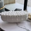 White roses arranged in a low oval ceramic vase