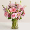 Pink mixed bouquet with roses and lilies in a clear glass vase