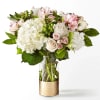 Bouquet of white and pale pink flowers in a glass vase