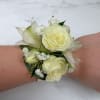 The Elegant Ivory Corsage features four white/ivory spray roses and two alstroemeria