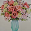 A lush cluster of pink roses and pale carnations forms the heart