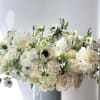 White floral arrangement in a blue vase