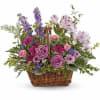 This lush lavender rose arrangement is a basket of beauty to brighten
