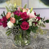 A lush cluster of hot pink, white and peach blooms makes this