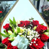 Bouquet of red roses with white alstroemeria in white wrap