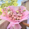 Soft blush peonies and rounded pink roses take center stage in this