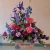 Lush layers of pink roses and purple iris create an immediate "wow"