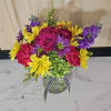 A bright colorful arrangement in a jar style vase.
