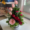 Compact white hat box of pink and red roses, gerbera and carnations