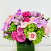 Hot pink and pale blush roses mingle with lavender alstroemeria and pops