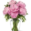 Pink peonies arranged in a clear glass vase