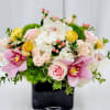 Soft blush and creamy white roses mingle with pale pink orchids to