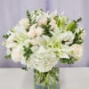A pool of large white lilies and clustered white hydrangeas gives this