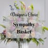 Sympathy basket of pastel flowers in a white wicker basket