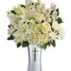 White floral arrangement in a silver vase with a cross cutout