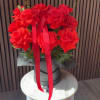 A lush cluster of vivid red roses shaped into a perfect, 