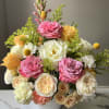 A romantic garden-style arrangement designed in an elegant white ceramic vase featuring