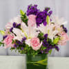 Soft pink roses and large soft pink lilies mingle with clusters of