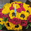 Bouquet of yellow sunflowers and hot pink roses in dark wrapping
