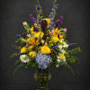 Sunlit yellow roses meet tall purple accents in a lively, garden-style bouquet