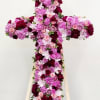 A large, dignified floral cross in soft pinks, lavender, whites and deep