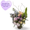 Soft lavender delphinium and pale yellow calla lilies lift a cascade of