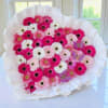 Bouquet of pink and white gerbera daisies wrapped in white paper
