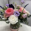 A mix of Garden roses and other premium blooms in a glass