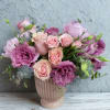 Pink and lavender bouquet in a ribbed blush vase
