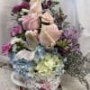 In a planter sized teacup all the strong garden flowers fill this