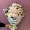 Bouquet of white roses with baby's breath wrapped in pale paper