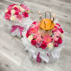 Two matching round bouquets wrapped in crisp white paper and tied with