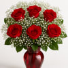 A stunning bouquet of half dozen vibrant red roses, elegantly arranged with