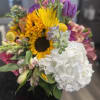 Mixed bouquet with sunflowers, white hydrangea, and purple blooms