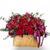 A lush, garden-style arrangement of rich red roses and delicate accents, beautifully