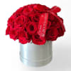 Red rose bouquet in a silver hatbox with a red ribbon