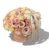 Round bouquet of pastel roses in a pink hat box with ribbon