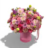 A vibrant garden style arrangement, bursting with pink roses, dahlias, lisianthus, carnations