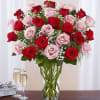 Bouquet of red and pink roses in a clear glass vase