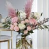 Pink and white floral arrangement in a clear glass vase