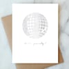 White party card with a silver disco ball and 