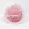 Pink rose bouquet wrapped in patterned paper with a Valentine’s Day ribbon
