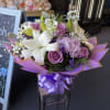 White lilies and lavender roses with pink chrysanthemums and greenery, wrapped in