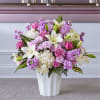 Pink and white flower arrangement in a white vase