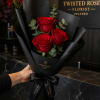 Three deep red roses set against matte black wrap create an instantly