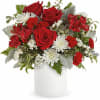 Deep red roses take center stage in this Lush Love flower arrangement