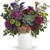 Lavender roses and a succulent give this floral arrangement a quietly surprising